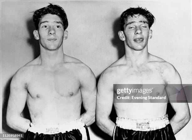 The Kray twins, aka criminals and gangsters Ronald 'Ronnie' Kray and Reginald 'Reggie' Kray , in boxing gear, London, UK, circa 1952.