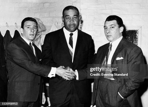 The Kray twins, aka criminals and gangsters Ronald 'Ronnie' Kray and Reginald 'Reggie' Kray , with American professional boxer Joe Louis , London,...