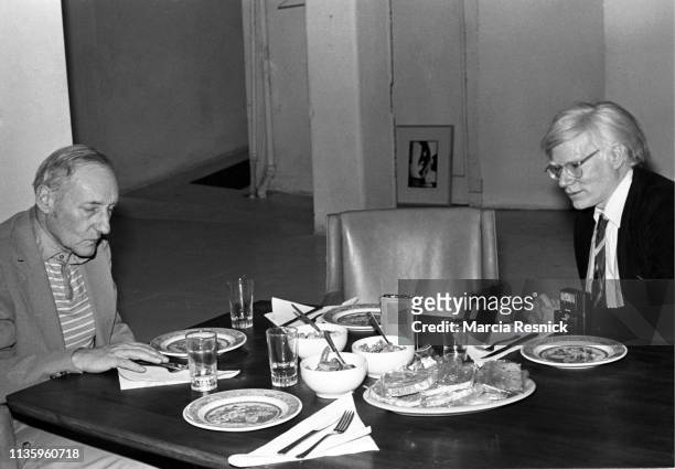 Photo of American Beat author William S Burroughs & Pop artist Andy Warhol as they dine together in Burrough's Bunker on the Bowery, New York, New...