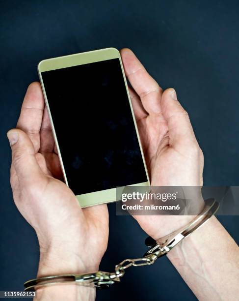 handcuffed to internet, smartphone addiction - prisoner phone stock pictures, royalty-free photos & images
