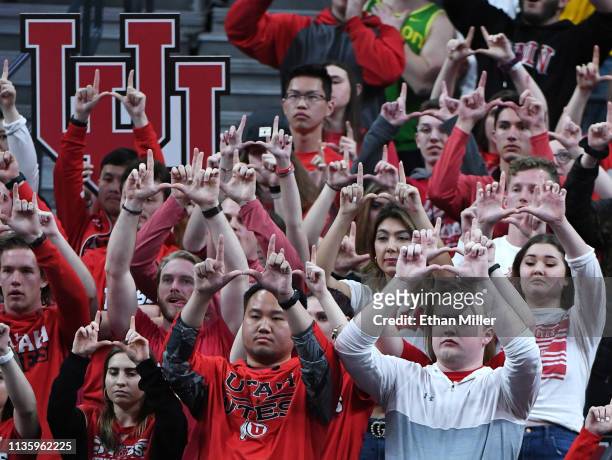 Utah Utes fans gesture as a player shoots a free throw during a quarterfinal game of the Pac-12 basketball tournament against the Oregon Ducks at...