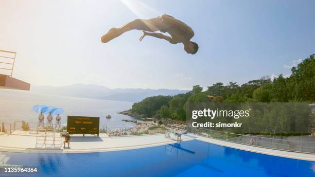 male diver diving into swimming pool - judge sports official stock pictures, royalty-free photos & images