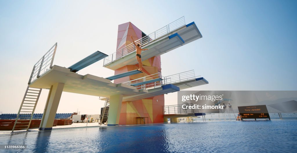Male diver standing on diving board before jump