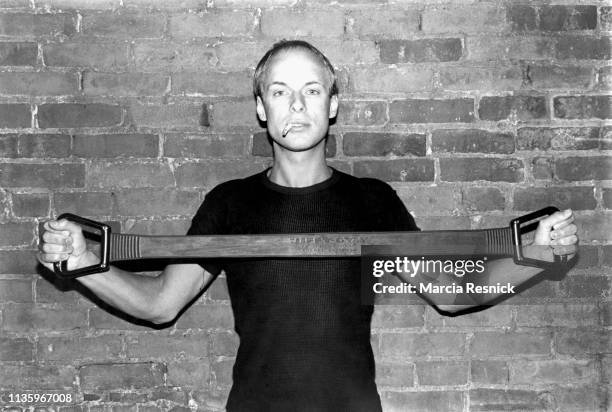 Photo of British Electronic musician, composer, and producer Brian Eno, a cigarette in his mouth, as he exercises with a resistance band, New York,...