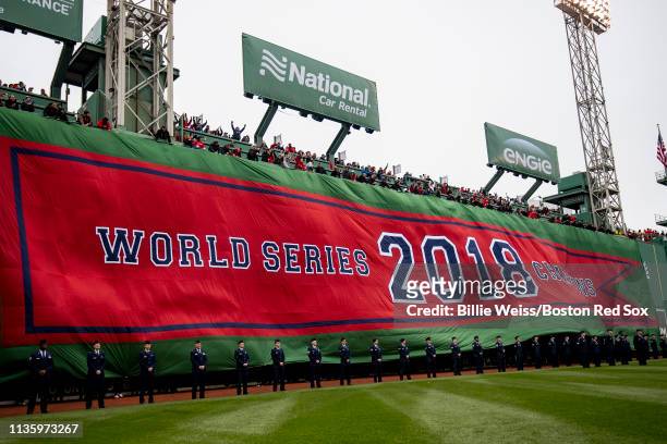 The Boston Red Sox 2018 World Series banner is dropped over the Green Monster during a 2018 World Series championship ring ceremony before the...