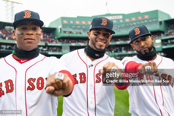 Rafael Devers, Xander Bogaerts, and Eduardo Nunez of the Boston Red Sox pose with their rings during a 2018 World Series championship ring ceremony...