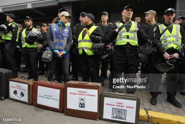 Police stand behind trunks with names of Ukrainian officials at a performance of National Corps activists, the Ukrainian far-right party, during an...