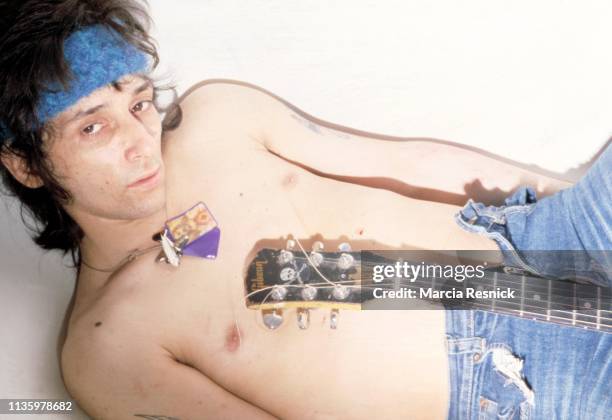 Photo of American Punk musician Johnny Thunders (born John Genzale as he poses, shirtless and with a guitar, in the bathtub at the Gramercy Park...