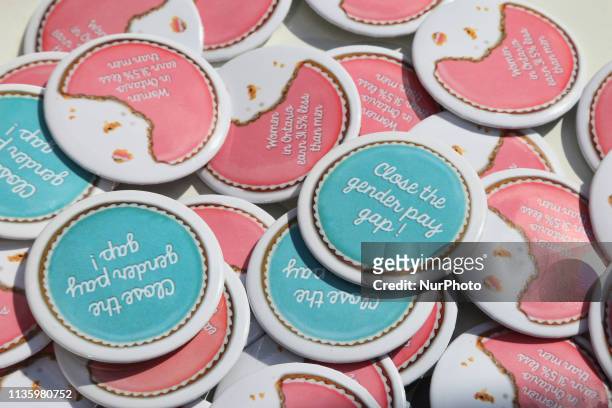 Close-up of buttons as women rally outside the Ontario Ministry of Labour building to demand equal pay for women and an end to the wage gap between...