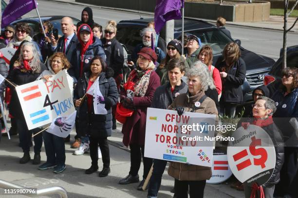 Women rally outside the Ontario Ministry of Labour building to demand equal pay for women and an end to the wage gap between the sexes on 'Equal Pay...