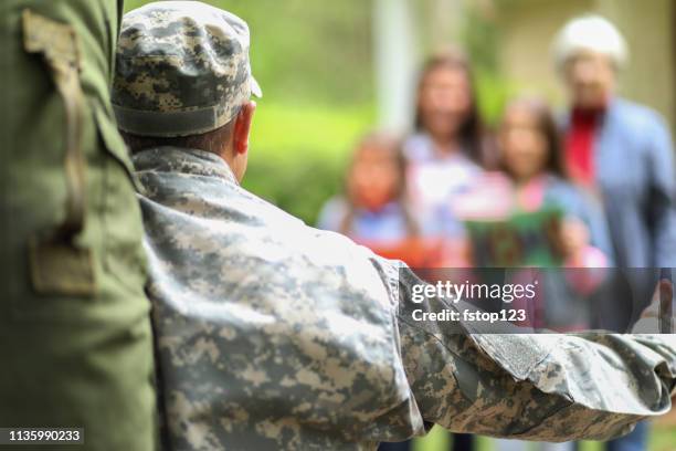 family welcomes home usa army soldier. - homecoming stock pictures, royalty-free photos & images