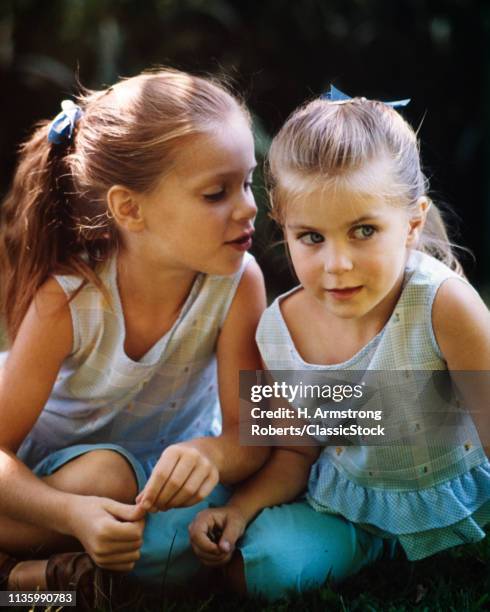 1960s TWO CUTE BLOND GIRLS SISTERS WHISPERING SHARING A SECRET RUMOR GOSSIP PLAYING NAUGHTY MISCHIEF