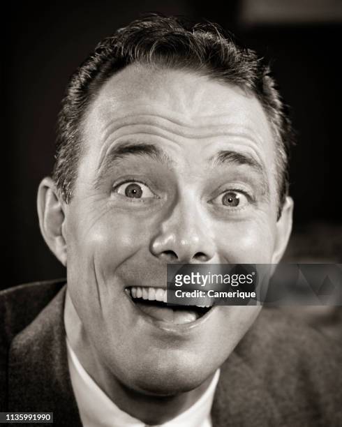 1950s HAPPY LAUGHING MAN FUNNY FACIAL EXPRESSION WITH EYES WIDE OPEN LOOKING AT CAMERA