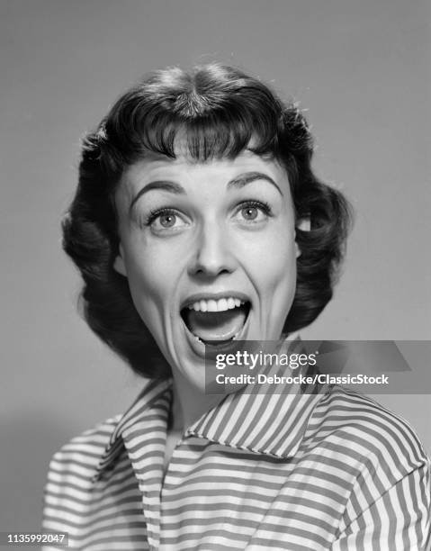 1950s 1960s WOMAN BRUNETTE SMILING LAUGHING MOUTH OPEN WIDE HAPPY FUNNY FACE LOOKING AT CAMERA WEARING STRIPED BLOUSE