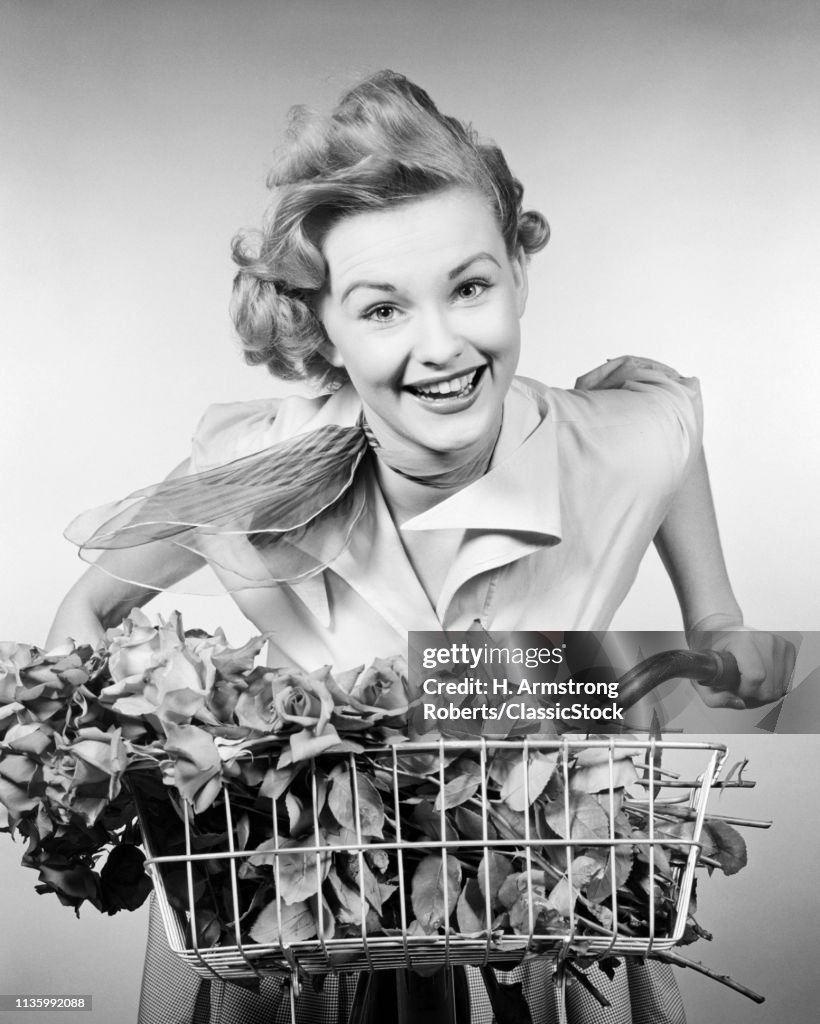 1950s WOMAN RIDING BICYCLE...