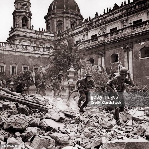 1940s AUGUST 5 1943 BRITISH SOLDIERS 8TH ARMY RUNNING OVER RUBBLE RUINS IN CATANIA SICILY ITALY