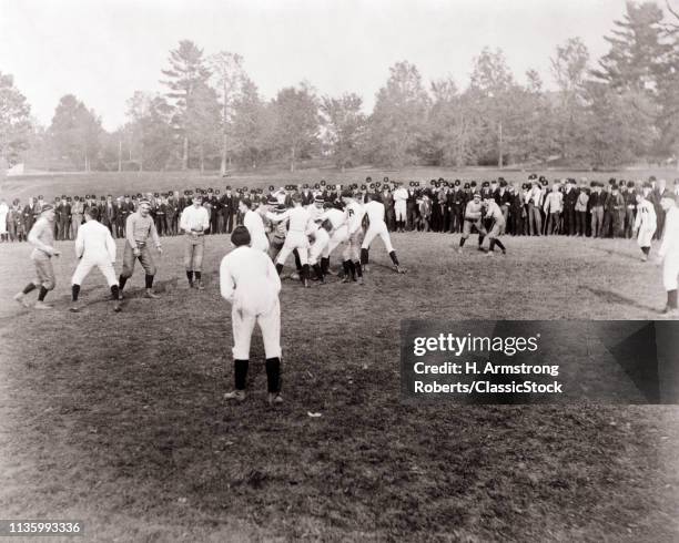 1880s COLLEGE FOOTBALL GAME CORNELL VS ROCHESTER WITH SPECTATORS LINED UP ALONG FIELD IN BACKGROUND