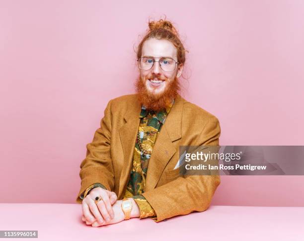 bearded hipster on pink background - man bun stock pictures, royalty-free photos & images