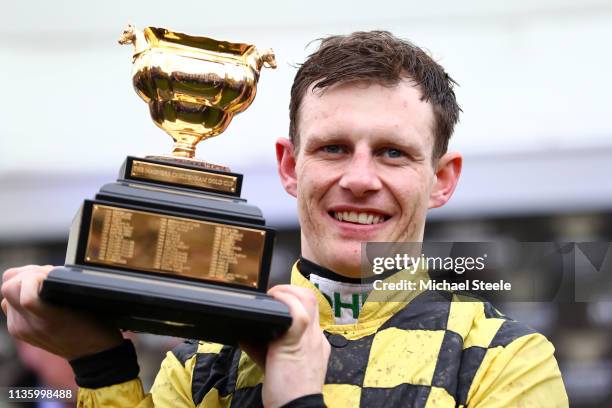 Jockey Paul Townend celebrates with the Gold Cup following his victory with horse Al Boum Photo in The Magners Cheltenham Gold Cup Steeple Chase...