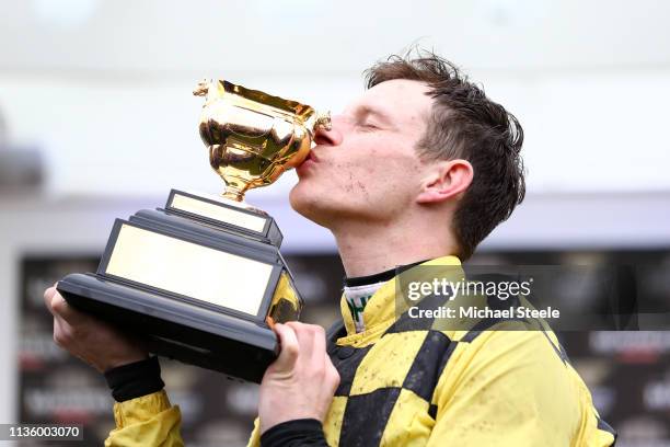 Jockey Paul Townend celebrates with the Gold Cup following his victory with horse Al Boum Photo in The Magners Cheltenham Gold Cup Steeple Chase...