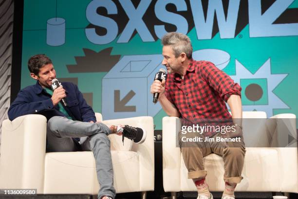 Adam Horowitz examines Michael Diamond's socks while they are interviewed live on stage during the 2019 SXSW Conference and Festival at the Austin...