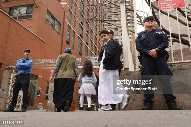 New York City police officers stand outside of a mosque in Manhattan following the mass shootings at two mosques in New Zealand on Friday on March...