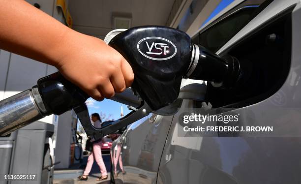 Child pumps gas for his father at a gas station in Los Angeles on April 9 as southern California gas prices, already the highest in the nation,...