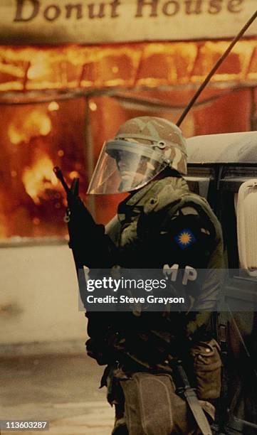 National Guardsman stands watch over a strip mall in south-central Los Angeles, April 30 during day two of the Los Angeles riots.