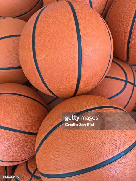 heap of basketballs close up - basketball hoop stockfoto's en -beelden