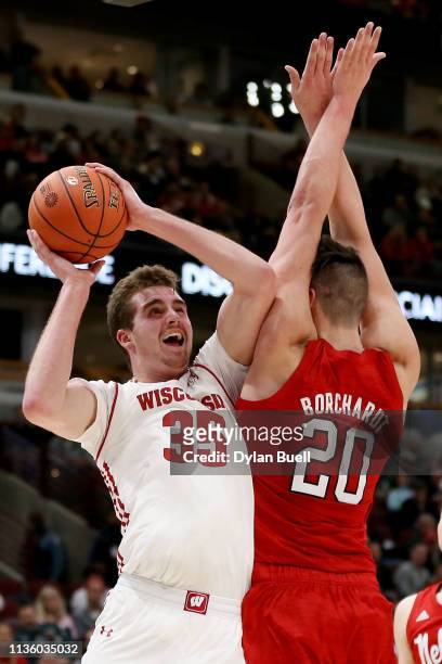 Nate Reuvers of the Wisconsin Badgers attempts a shot while being guarded by Tanner Borchardt of the Nebraska Huskers in the first half during the...