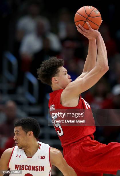 Isaiah Roby of the Nebraska Huskers attempts a shot over D'Mitrik Trice of the Wisconsin Badgers in the first half during the quarterfinals of the...