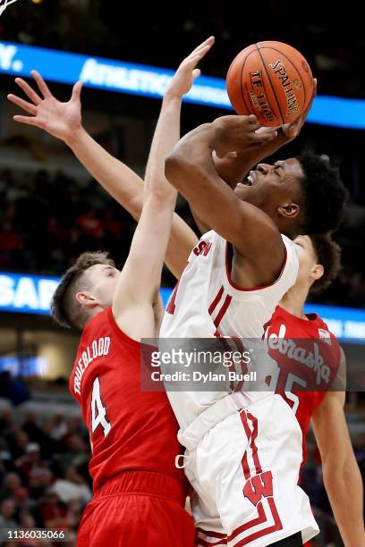Khalil Iverson of the Wisconsin Badgers attempts a shot while being guarded by Johnny Trueblood of the Nebraska Huskers in the first half during the...