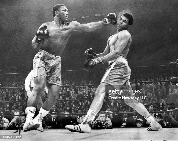 Joe Frazier, left, hits Muhammad Ali during the 15th round of their heavyweight boxing title fight at New York's Madison Square Garden on March 8,...
