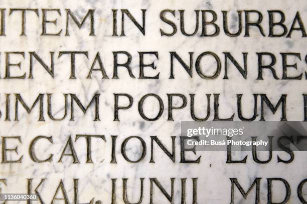 latin script engraving on marble as seen on a wall in venice, italy - majuscule script photos et images de collection