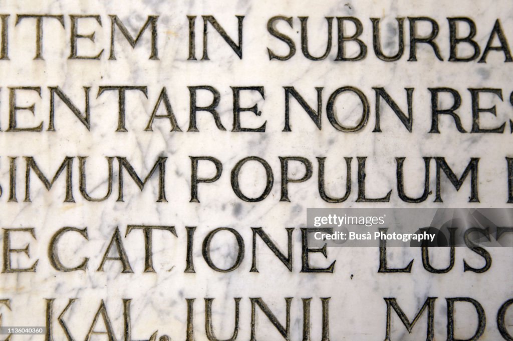 Latin script engraving on marble as seen on a wall in Venice, Italy