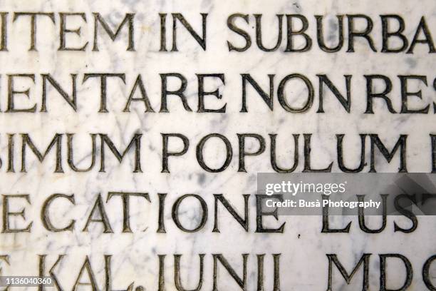 latin script engraving on marble as seen on a wall in venice, italy - ancient roman stock pictures, royalty-free photos & images