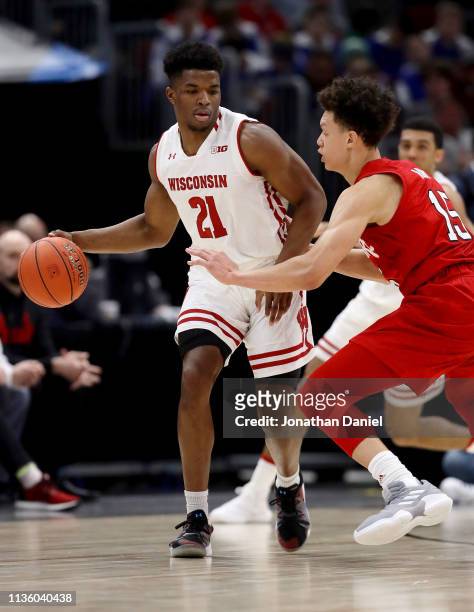 Khalil Iverson of the Wisconsin Badgers dribbles the ball while being guarded by Isaiah Roby of the Nebraska Huskers in the first half during the...