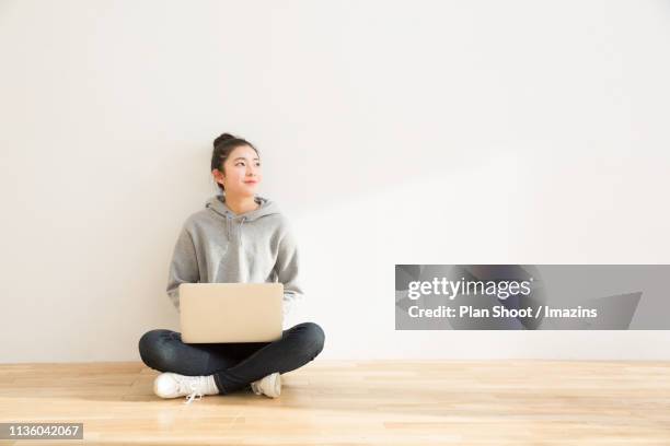 teenage girl sitting on the floor and using laptop - korean teen stock pictures, royalty-free photos & images