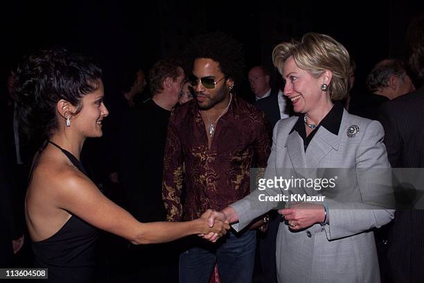 First Lady Hillary Clinton shakes hands with Salma Hayek as Lenny Kravitz looks on