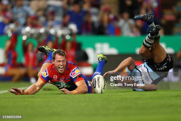 Tim Glasby of the Newcastle Knights scores a try during round one NRL match between the Newcastle Knights and the Cronulla-Sutherland Sharks at...