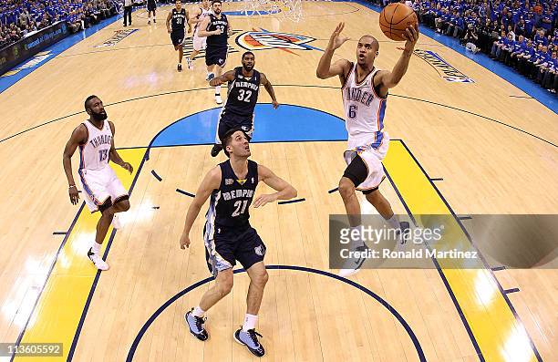 Guard Eric Maynor of the Oklahoma City Thunder takes a shot against Greivis Vasquez of the Memphis Grizzlies in Game Two of the Western Conference...