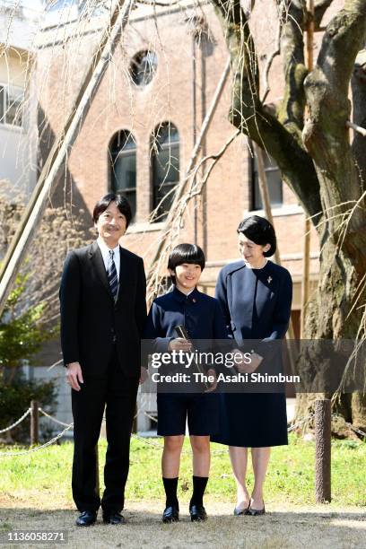 Prince Hisahito poses for photographs with his parents Prince Akihito and Princess Kiko of Akishino after attending the graduation ceremony of...