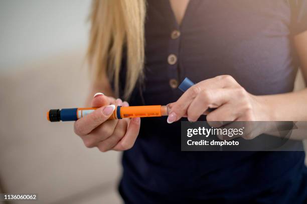 injection with insulin pen - insulin pen stock pictures, royalty-free photos & images