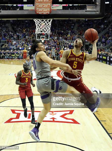 Lindell Wigginton of the Iowa State Cyclones drives toward the basket as Mike McGuirl of the Kansas State Wildcats defends during the semifinal game...