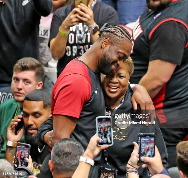 The Miami Heat's Dwyane Wade hugs his mom, Jolinda, before his last game as the Heat play host to the Philadelphia 76ers at the AmericanAirlines...
