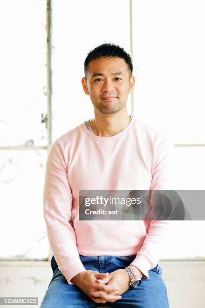 portrait of a man - asian man sitting casual imagens e fotografias de stock