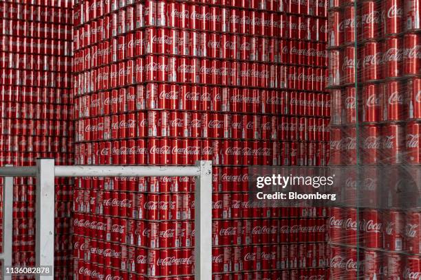 Empty Coca-Cola Co. Brand Coke cans sit stacked in a storage facility at the Moon Beverages Ltd. Coca-Cola Happiness Factory in Greater Noida, Uttar...