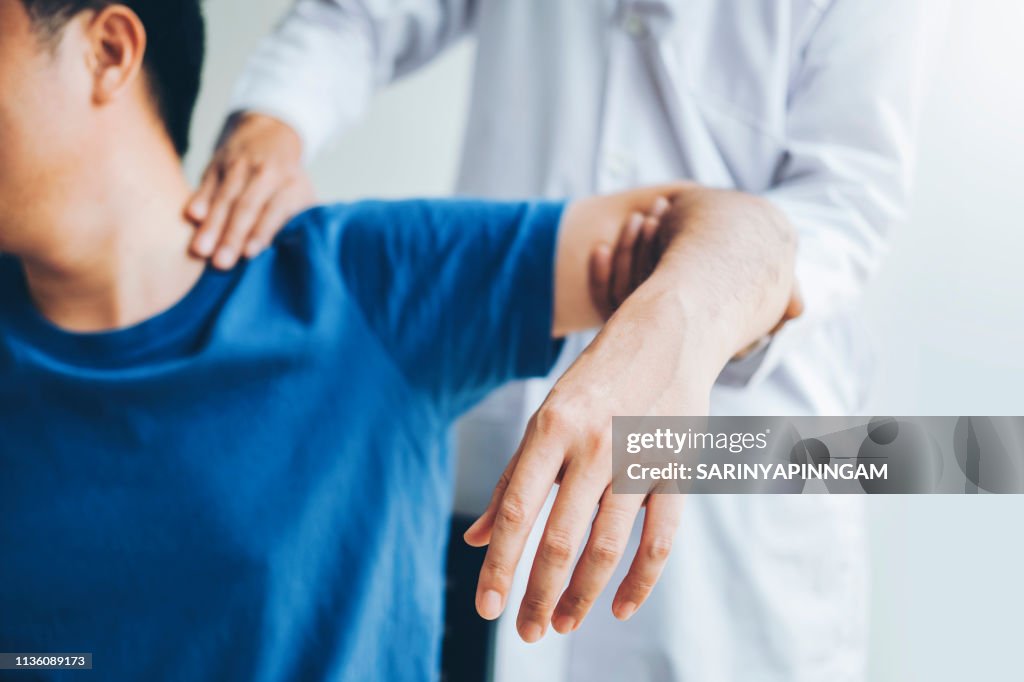 Physical Doctor consulting with patient About Shoulder muscule pain problems Physical therapy diagnosing concept
