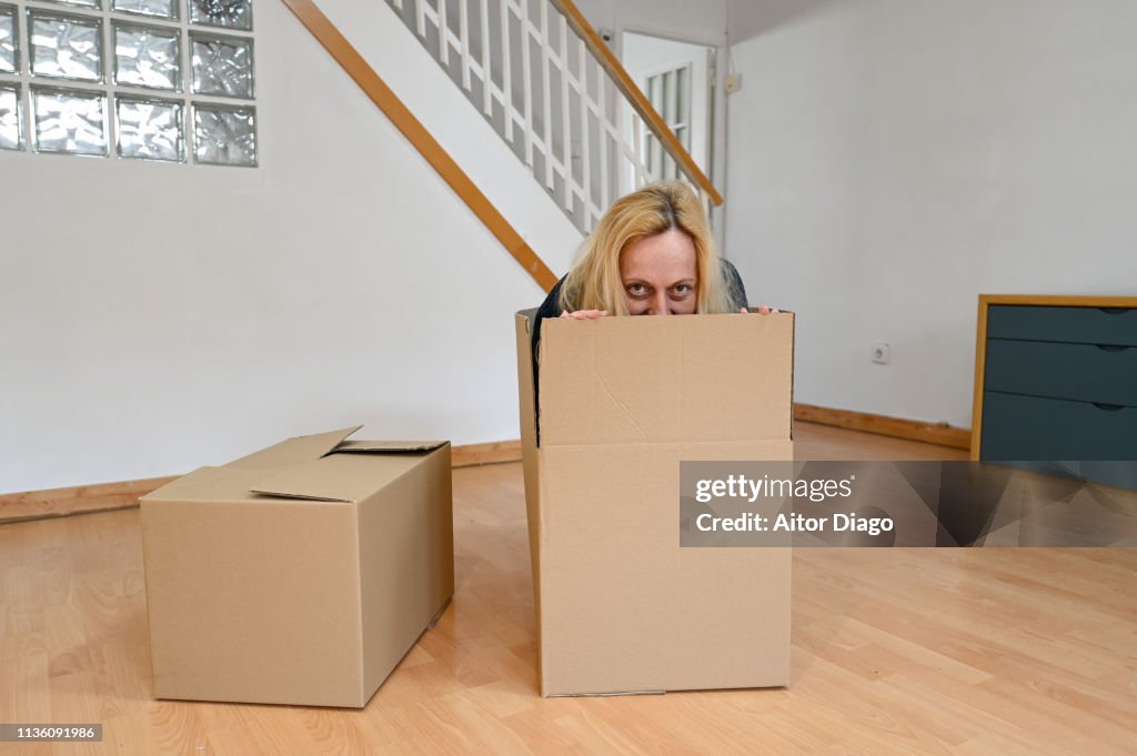 Hiding In Box Happy Woman Hide In A Cardboard Box Moving High-Res Stock Photo - Getty ...