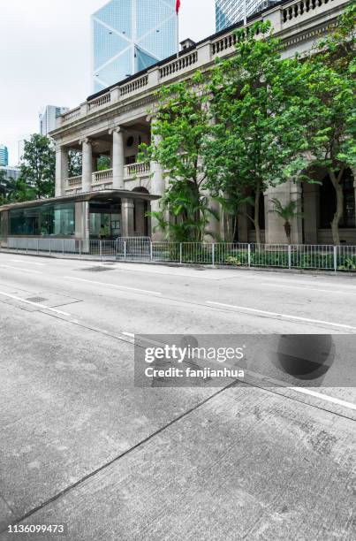 urban road through legislative council in central hong kong - hong kong legislative council stock pictures, royalty-free photos & images